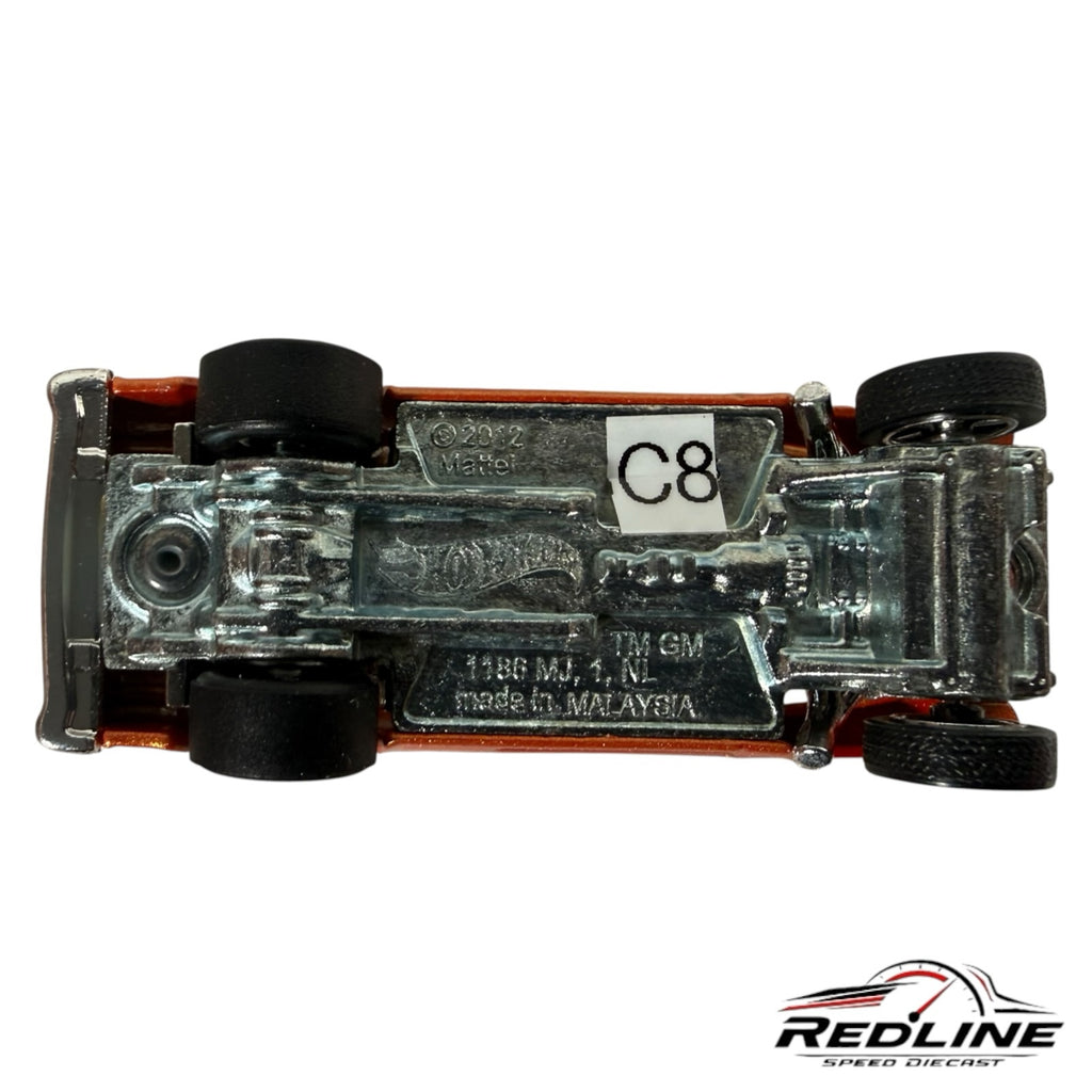 Underside view of a Redline Speed Diecast 55 Chevy Bel Air Gasser showing the chrome metal chassis and black tires.