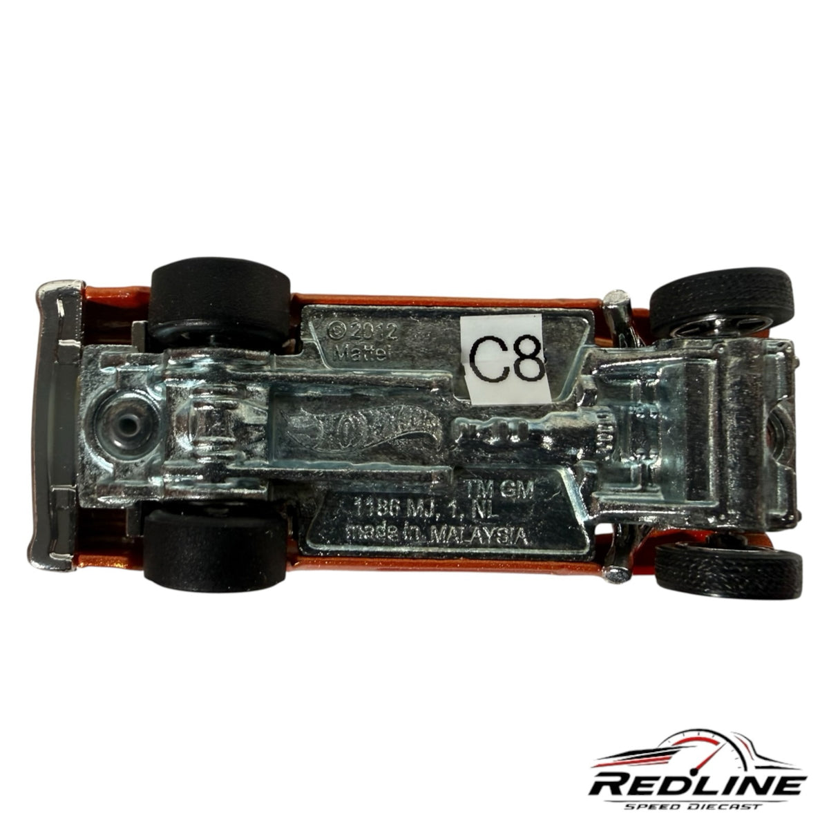 Underside view of a Redline Speed Diecast 55 Chevy Bel Air Gasser showing the chrome metal chassis and black tires.