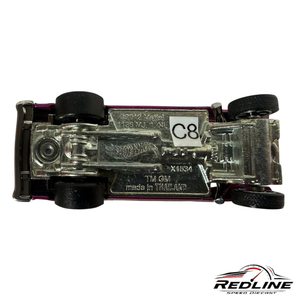 Underside view of a Redline Speed Diecast 1955 Chevy gasser model showing chrome chassis and manufacturer markings