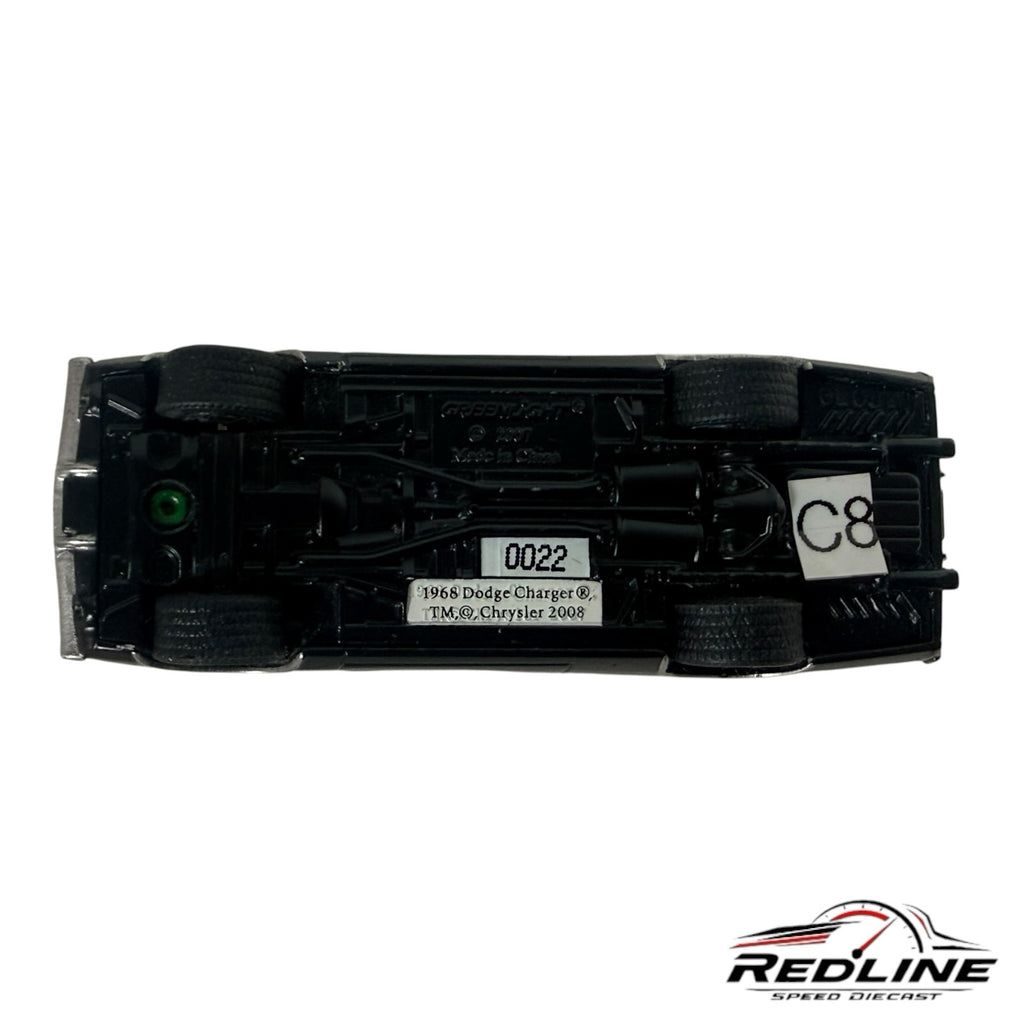 Underside view of a Redline Speed Diecast 1968 Dodge Charger model car showing chassis details and markings.