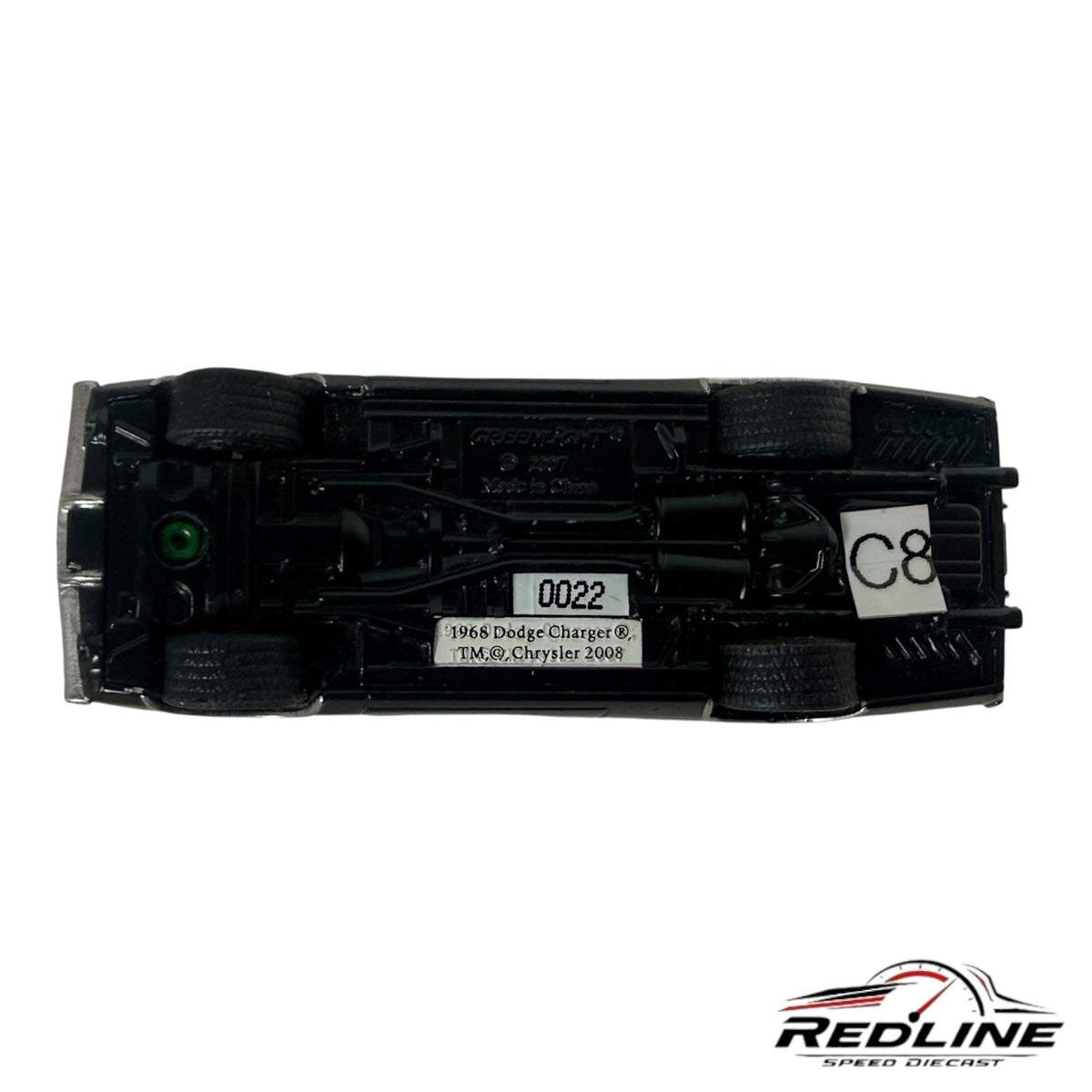 Underside view of a Redline Speed Diecast 1968 Dodge Charger model car showing chassis details and markings.