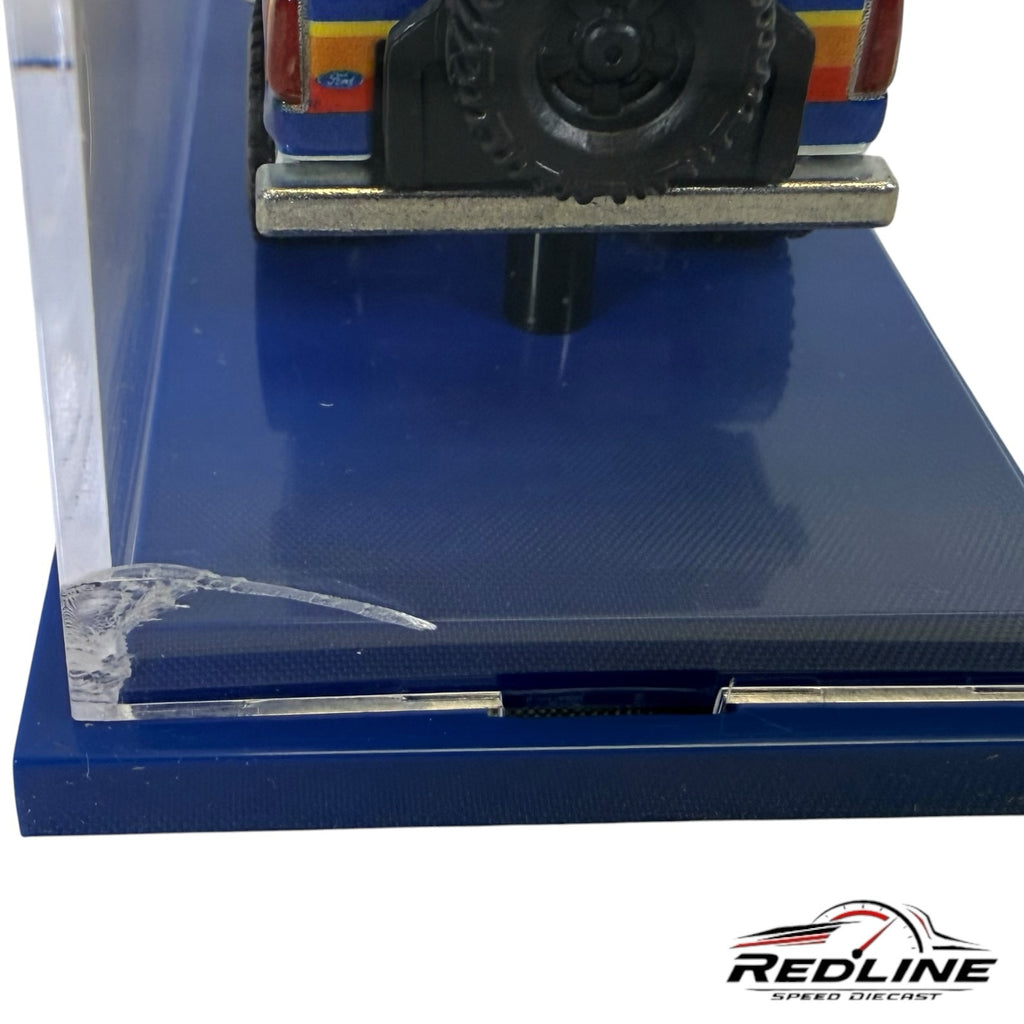 Redline Speed Diecast 1985 Ford Bronco model in blue and white with Wrangler graphics, shown in an acrylic display case