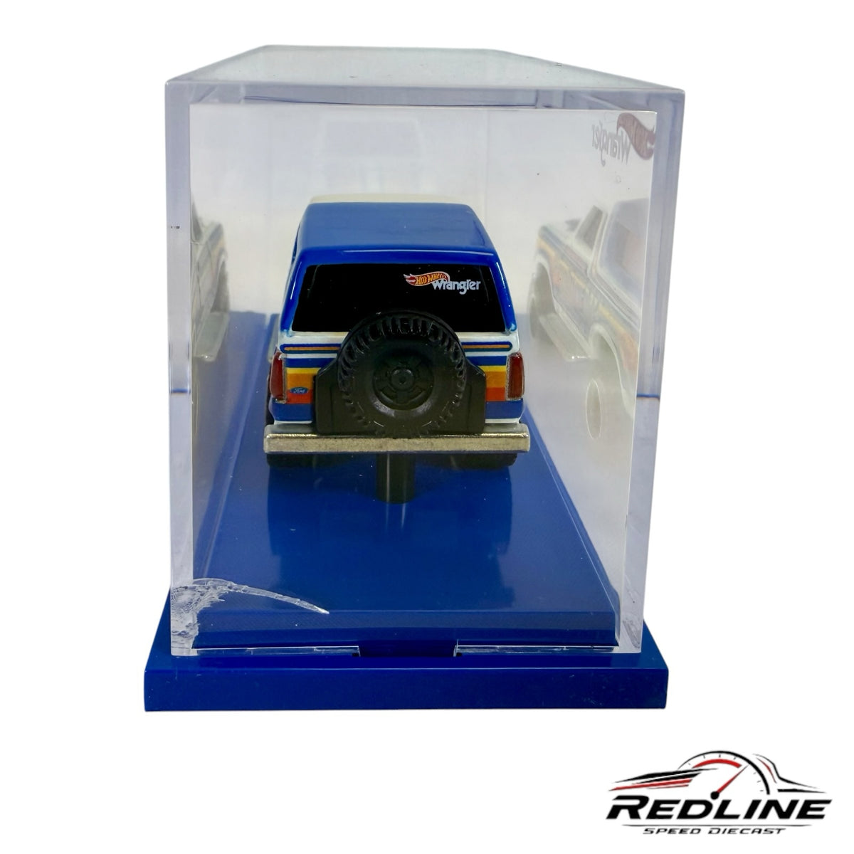 Redline Speed Diecast 1985 Ford Bronco Hot Wheels Wrangler model in blue and white with rear spare tire in display case