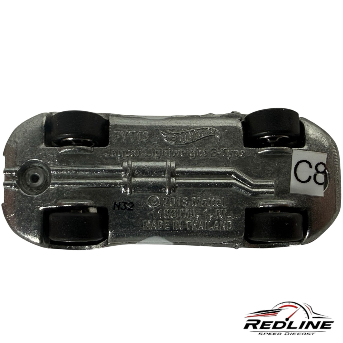Underside view of a Redline Speed Diecast silver Jaguar Lightweight E-Type model car showing chassis details