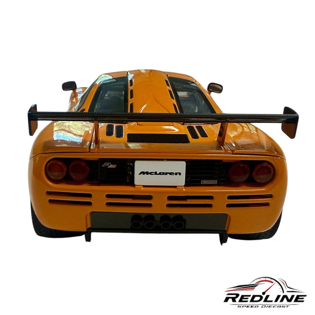 Rear view of a vibrant orange Redline Speed Diecast McLaren F1 LM 1:18 scale model with a prominent rear wing.