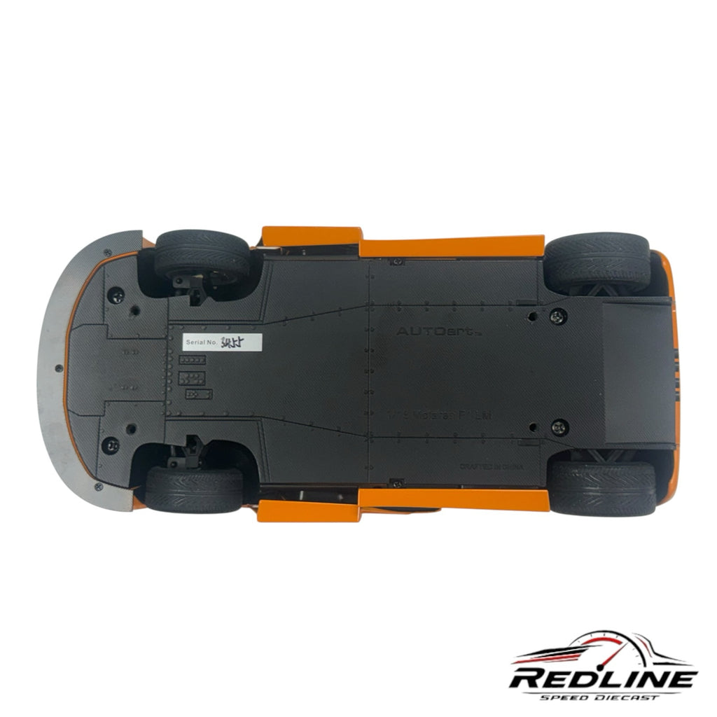 Underside view of Redline Speed Diecast AUTOart McLaren F1 LM 1:18 scale model showing black chassis and orange body