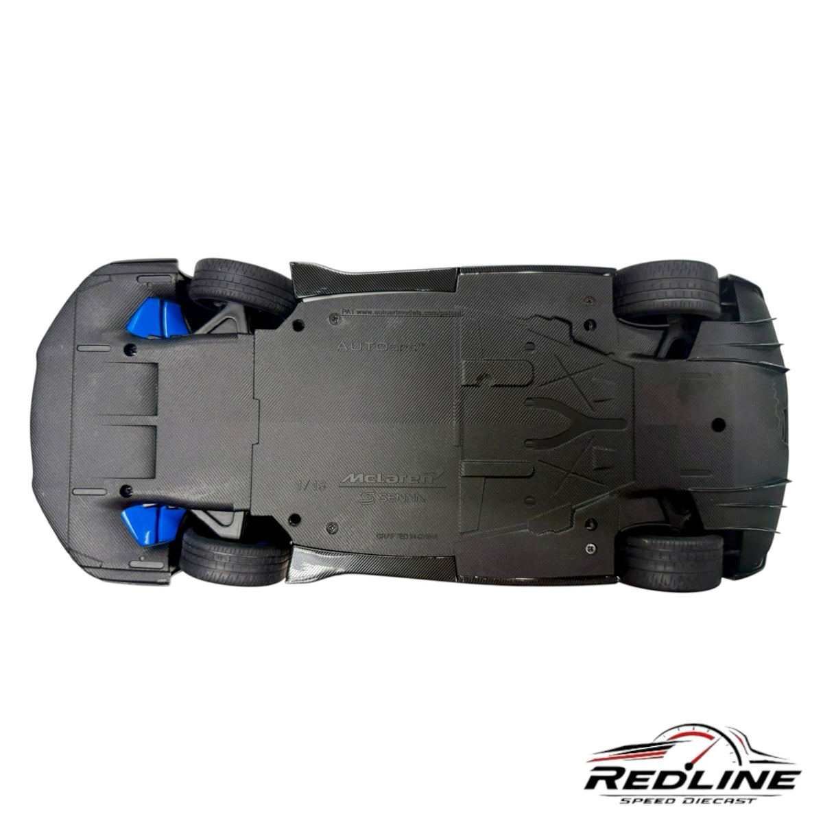 Redline Speed Diecast McLaren Senna model car showing the detailed carbon fiber textured undercarriage and blue brakes