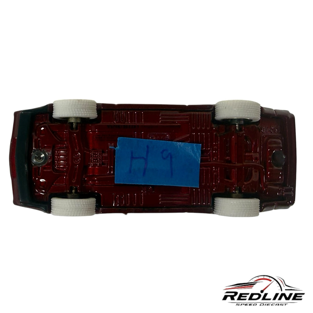 Redline Speed Diecast 1:64 scale Mitsubishi Starion model car, underside view showing maroon chassis and white tires.