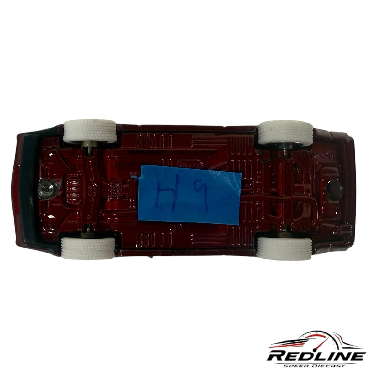 Redline Speed Diecast 1:64 scale Mitsubishi Starion model car, underside view showing maroon chassis and white tires.
