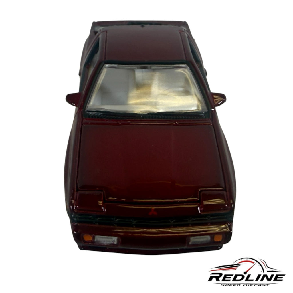 Redline Speed Diecast 1:64 scale metallic maroon Mitsubishi Starion model car, front view showing wedge silhouette.