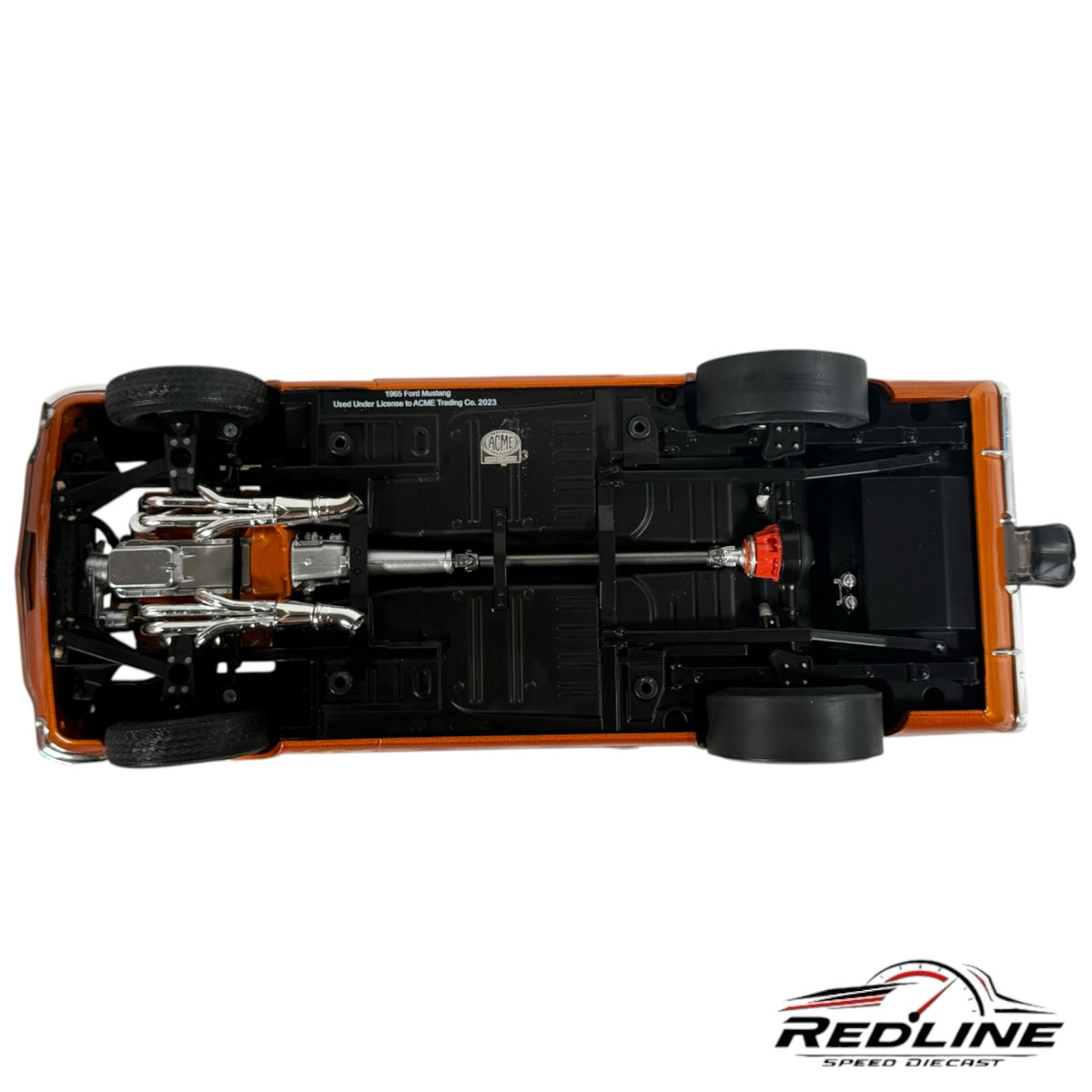 Underside view of Redline Speed Diecast 1:18 scale 1965 Ford Mustang model showing chrome exhaust and chassis detail.