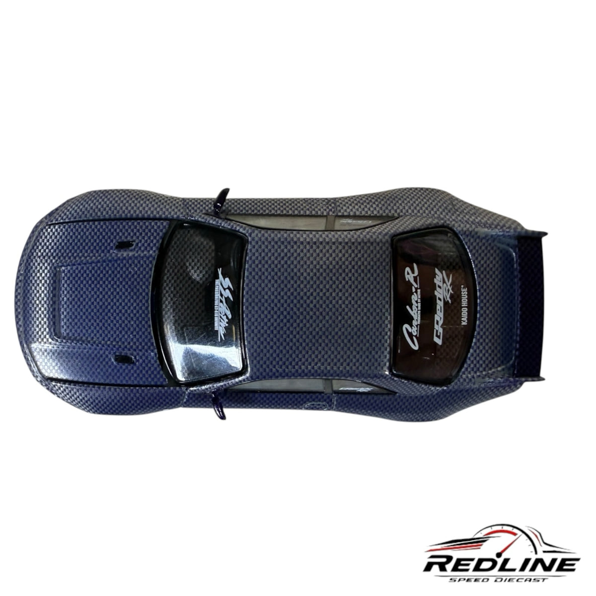 Redline Speed Diecast KAIDO HOUSE Nissan Skyline R33 model car with a detailed carbon fiber weave finish, top view.