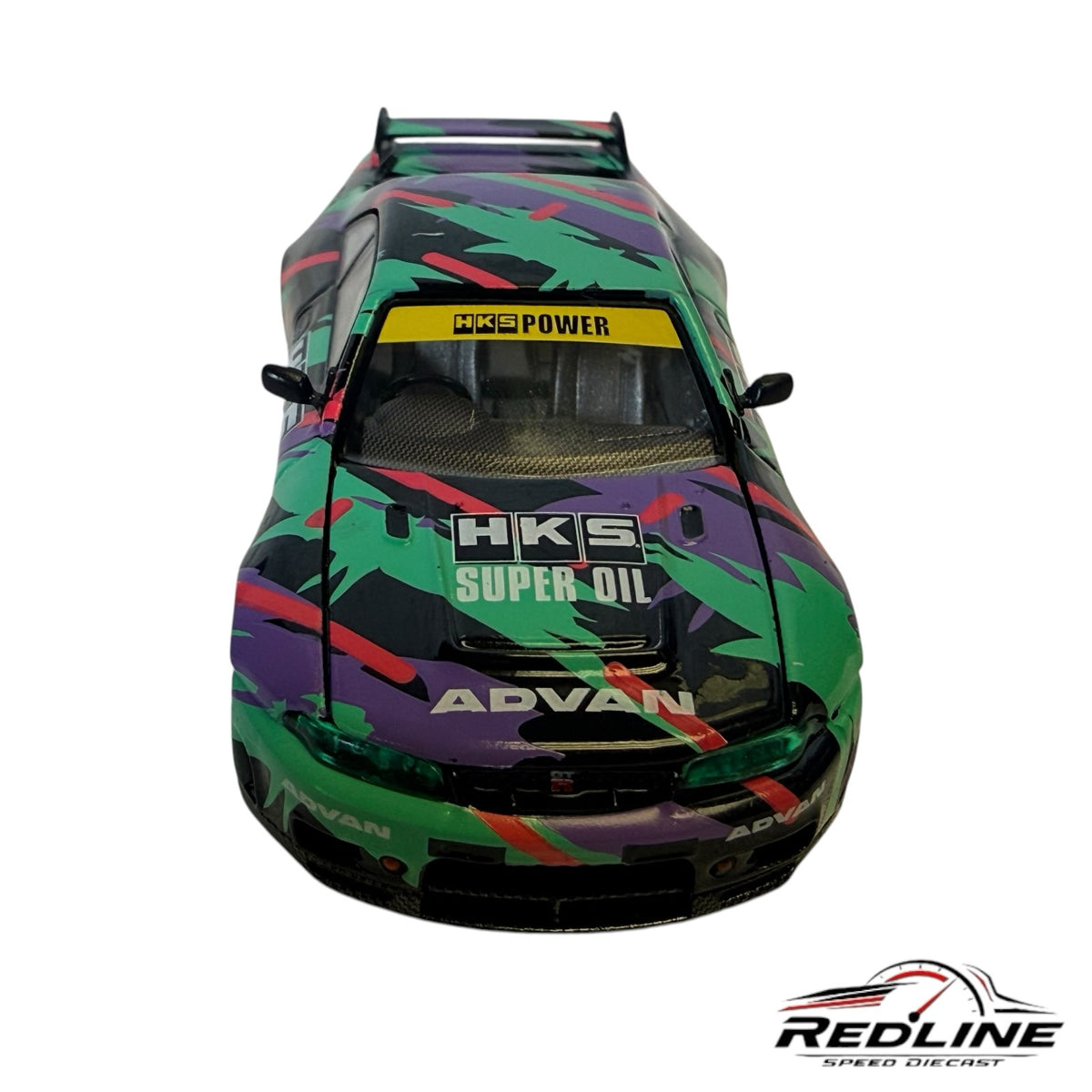 Redline Speed Diecast 1:64 scale Nissan Skyline GT-R R33 model with HKS livery, green and purple racing graphics.