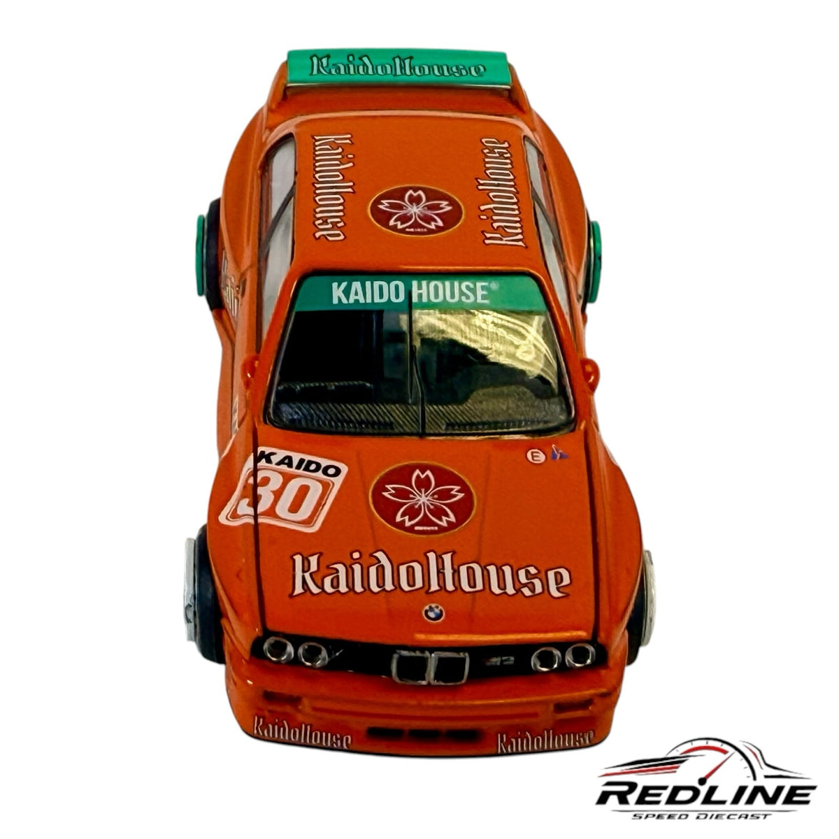 Redline Speed Diecast orange BMW M3 Kaido House V1 model car with sponsor decals and teal rear spoiler
