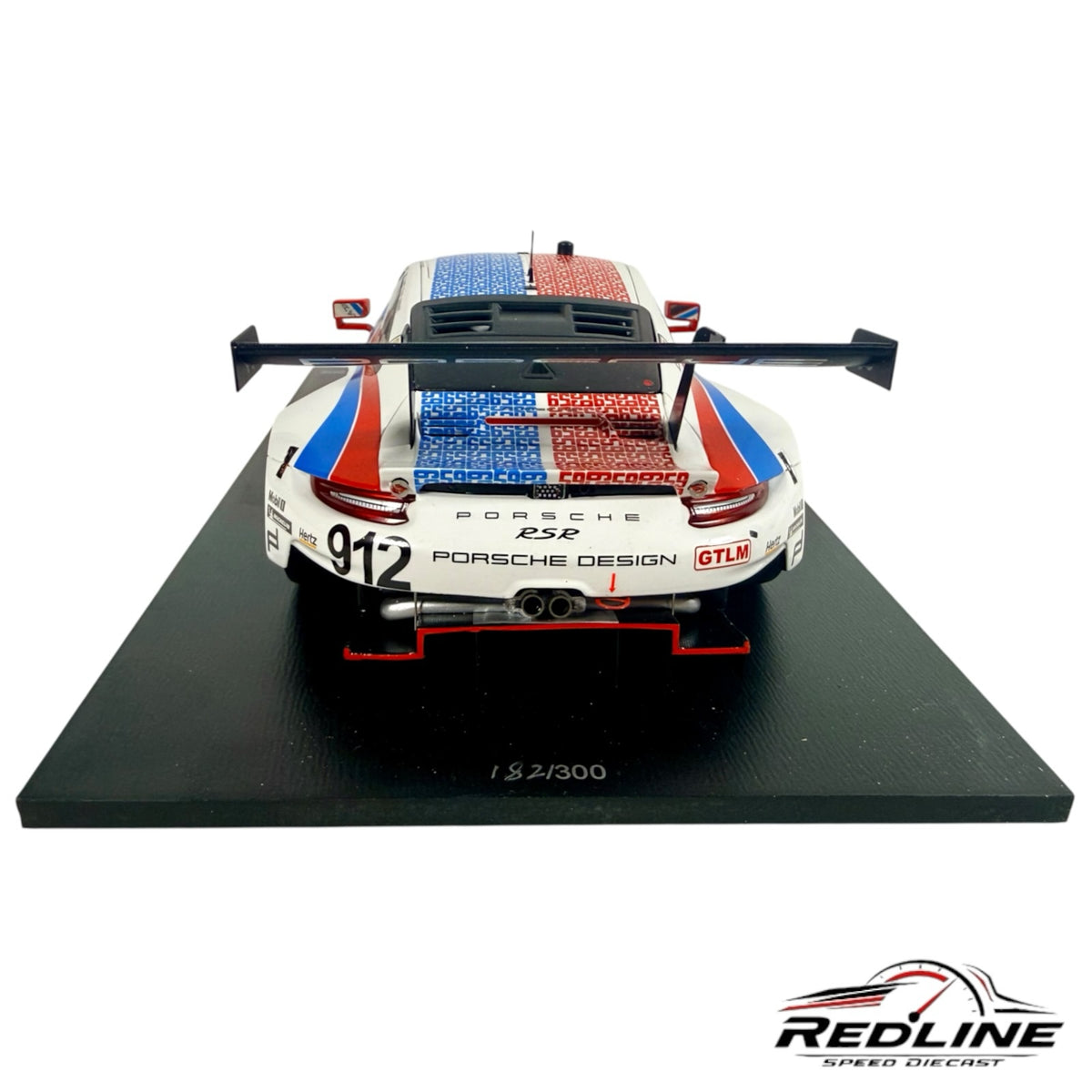 Redline Speed Diecast 1:18 scale Porsche 911 RSR race car model with red, white, and blue livery on a display base.