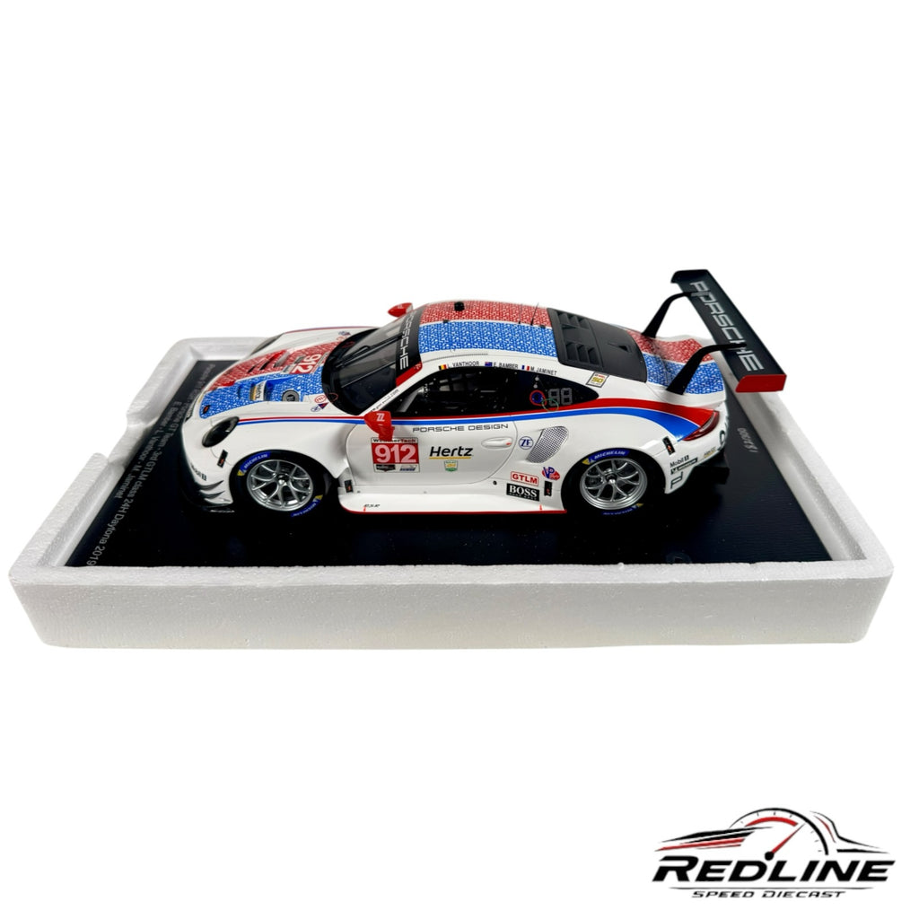 Redline Speed Diecast 1:18 scale Porsche 911 RSR model in white, red, and blue livery on a display base.