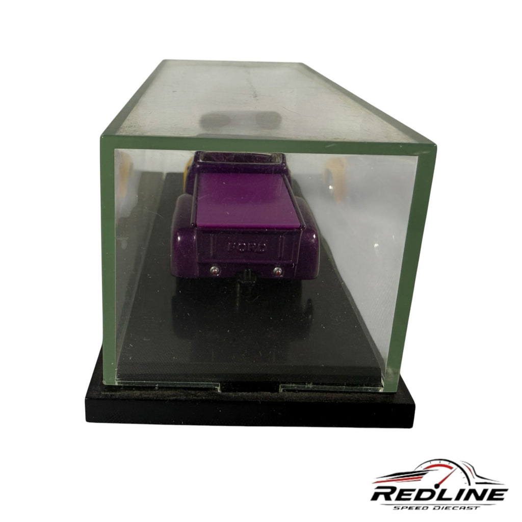 Redline Speed Diecast vintage purple Ford pickup truck model in a clear protective display case with a black base.