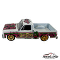 Redline Speed Diecast Rat Fink custom pickup truck model in white with pink and green graphics and gold wheels.