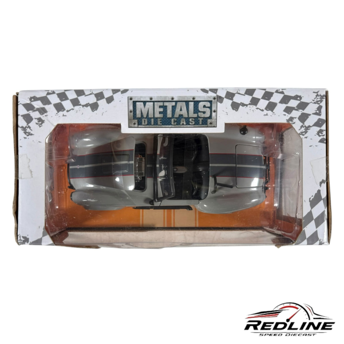 Redline Speed Diecast 1965 Shelby Cobra 427 model car in grey with racing stripes, viewed from above in packaging.