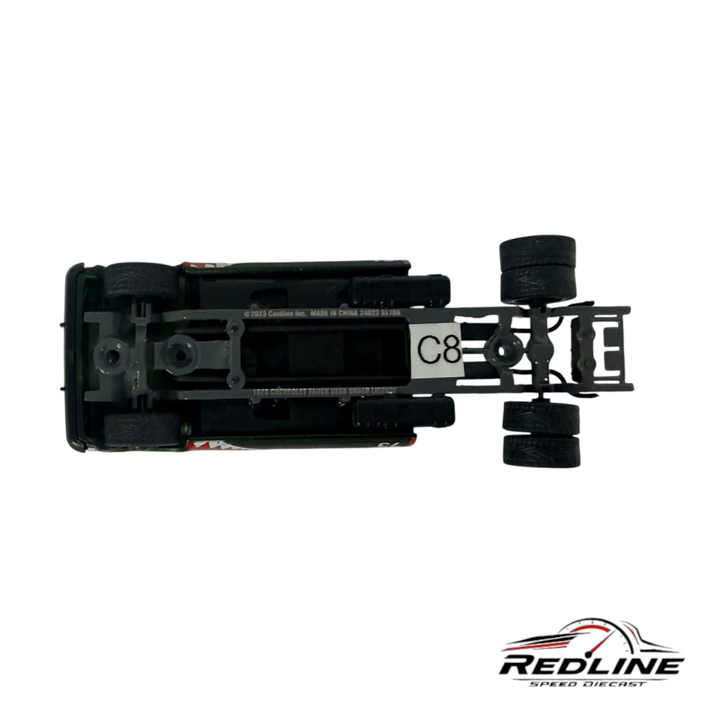 Underside view of a Redline Speed Diecast custom square body pickup truck model showing the dually rear axle chassis.