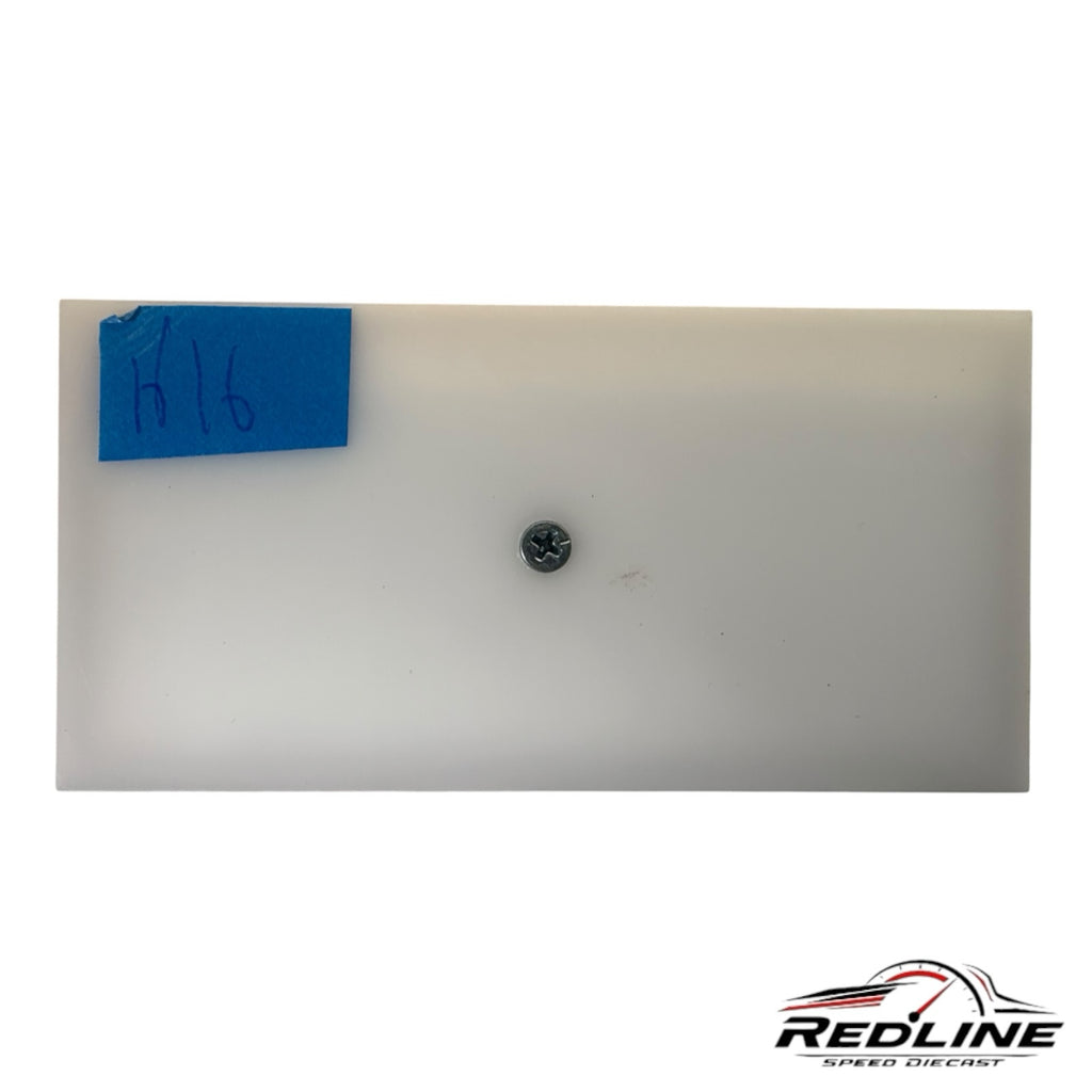 Redline Speed Diecast white plastic base plate with a central mounting screw and blue tape label for display mounting