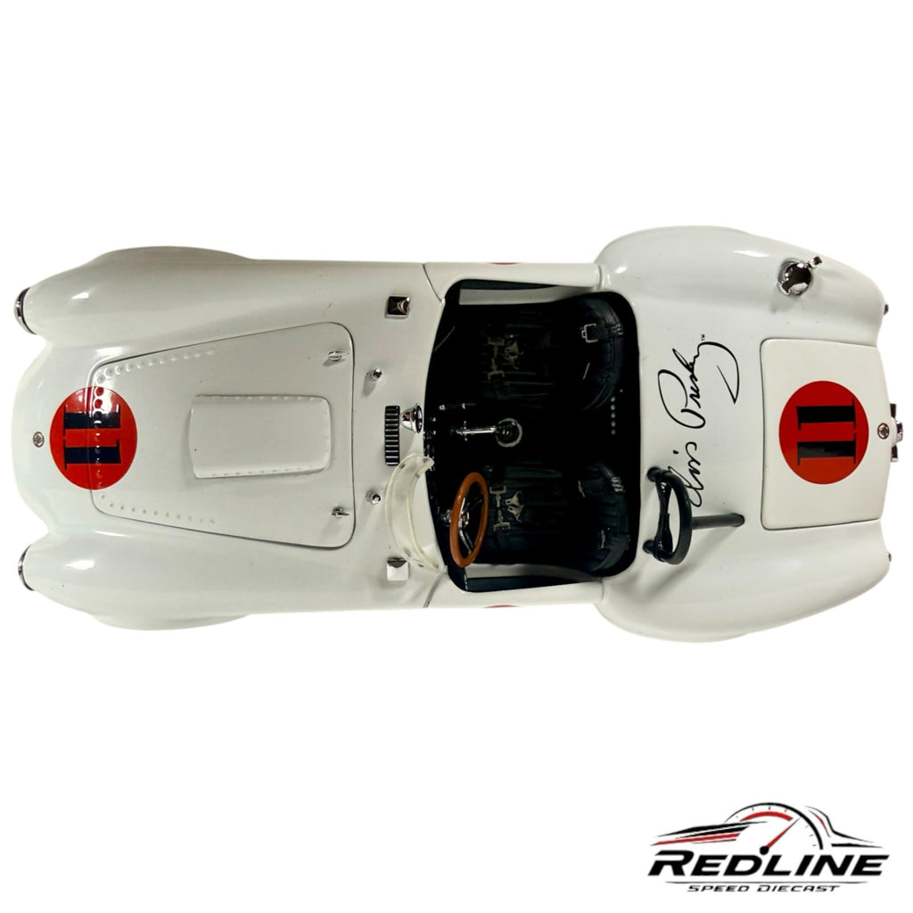 Top view of a white Redline Speed Diecast Shelby Cobra model car with red number 11 decals and a signature on the hood