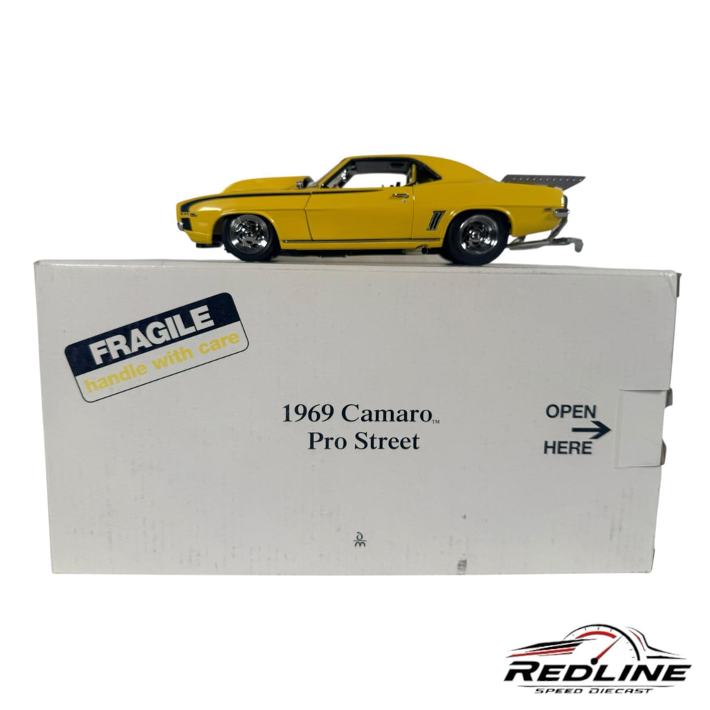 Redline Speed Diecast 1969 Chevrolet Camaro Pro Street model car in yellow with rear wheelie bars on its display box