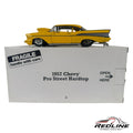 Redline Speed Diecast 1957 Chevrolet Pro Street Hardtop model car in vibrant yellow with wide rear tires on its box.