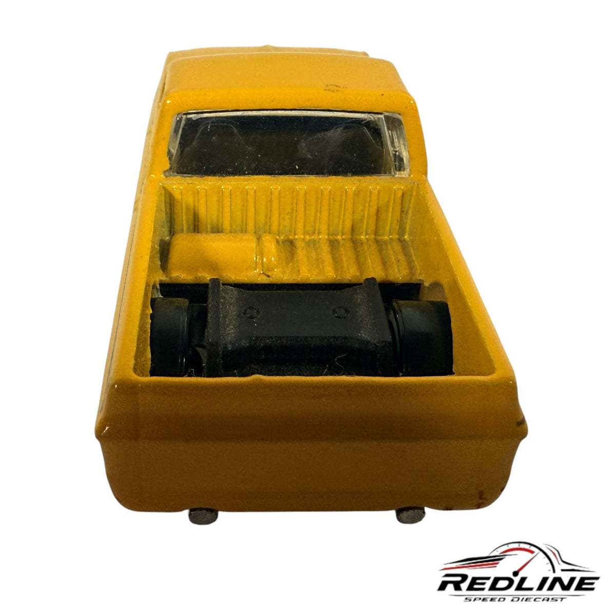 Redline Speed Diecast 1983 Chevy Silverado pickup truck in yellow, rear view showing the truck bed and black wheels.